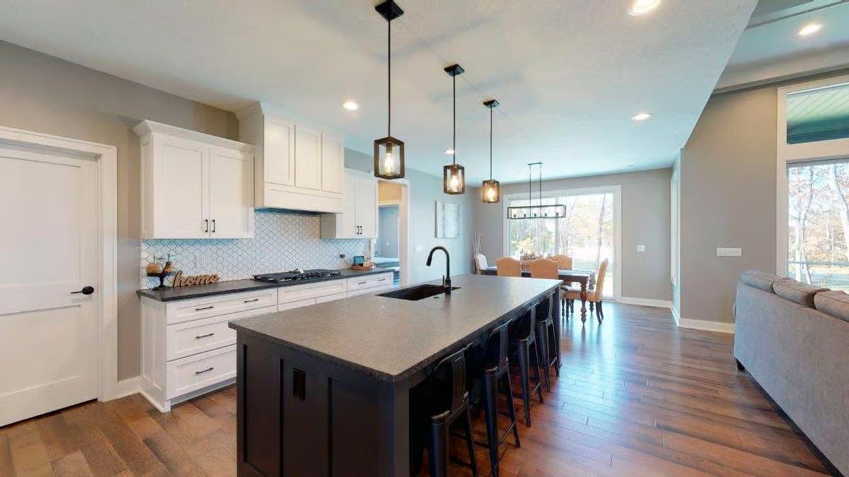 Dark Island, White Cabinets, and Pendant Lights That Actually Earn Their Keep
