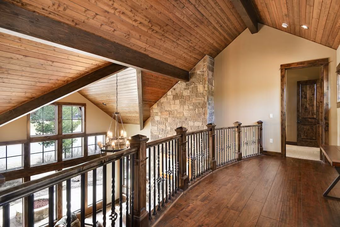 Wrought Iron Balusters and Stone That Earn Every Square Foot of This Upper Hall