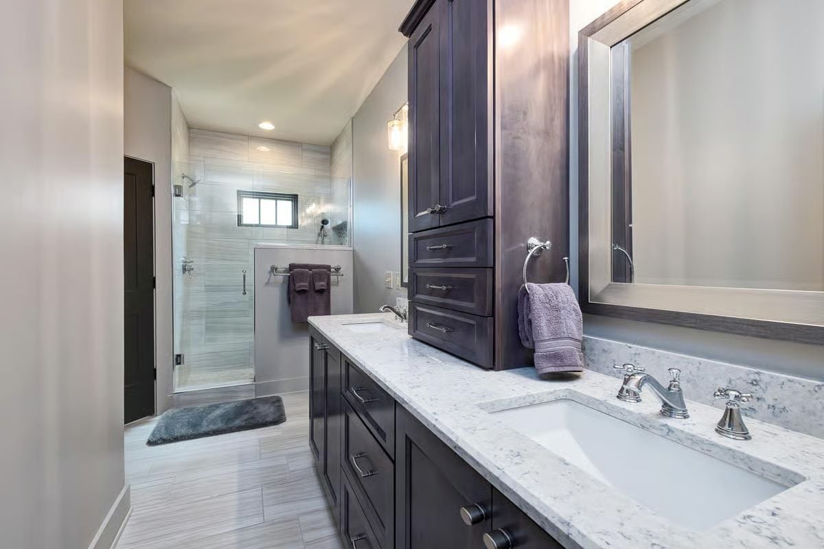 Dark Cabinetry and Marble Countertops Set a Serious Tone in the Master Bath