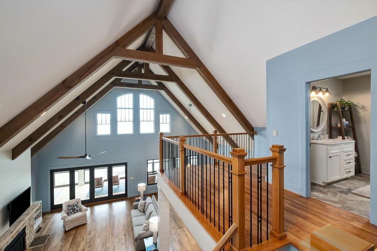 Exposed Timber Trusses and Open Railings Turn an Upper Landing Into a Destination