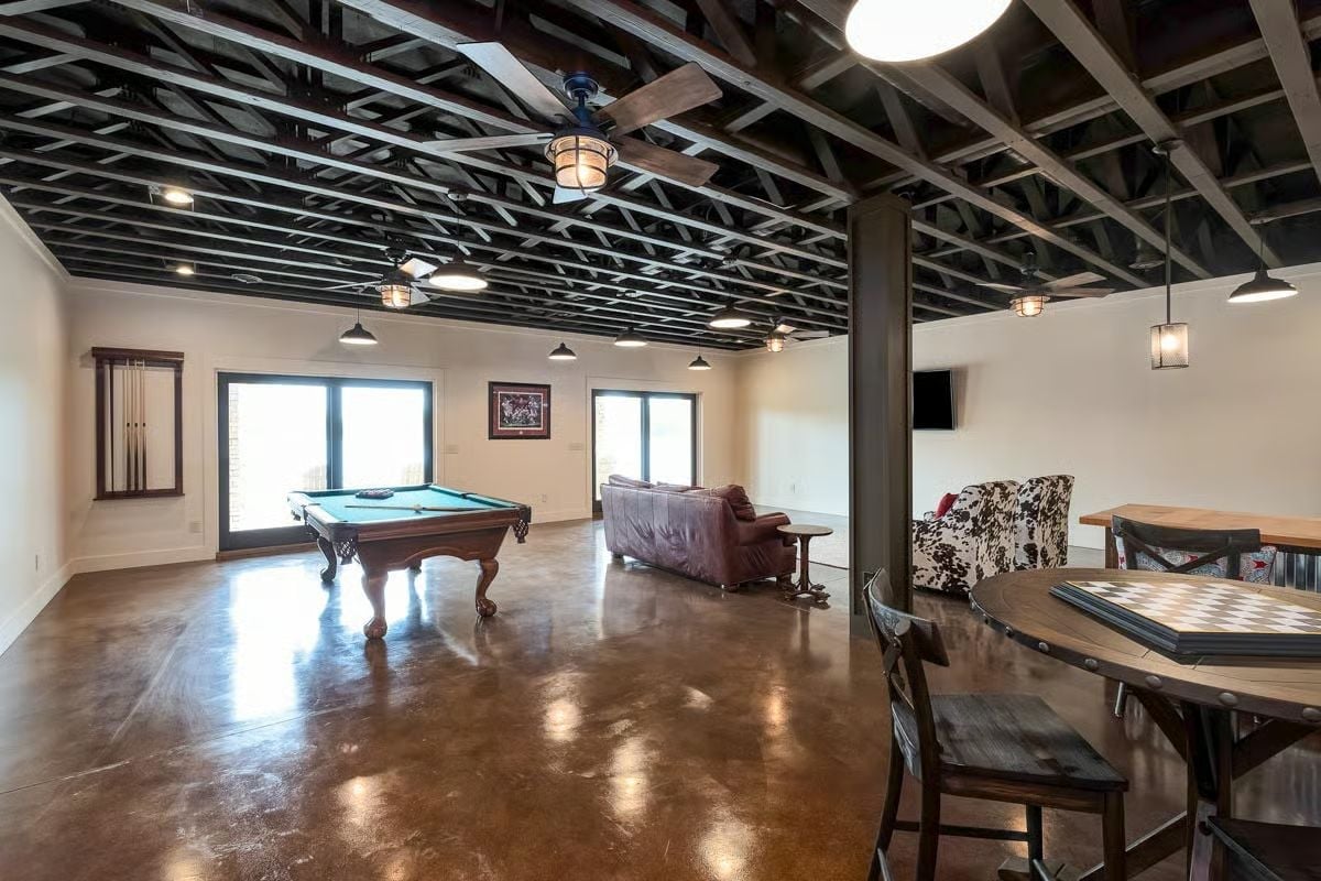 Painted Black Joists and Polished Concrete Make This Game Room Work Hard