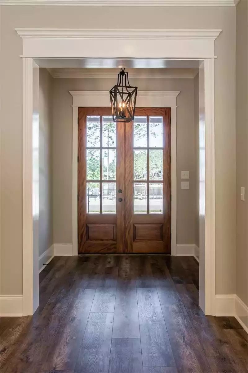 Dark Wood Floors and a Lantern Pendant Make This Entry Feel Like a Welcome