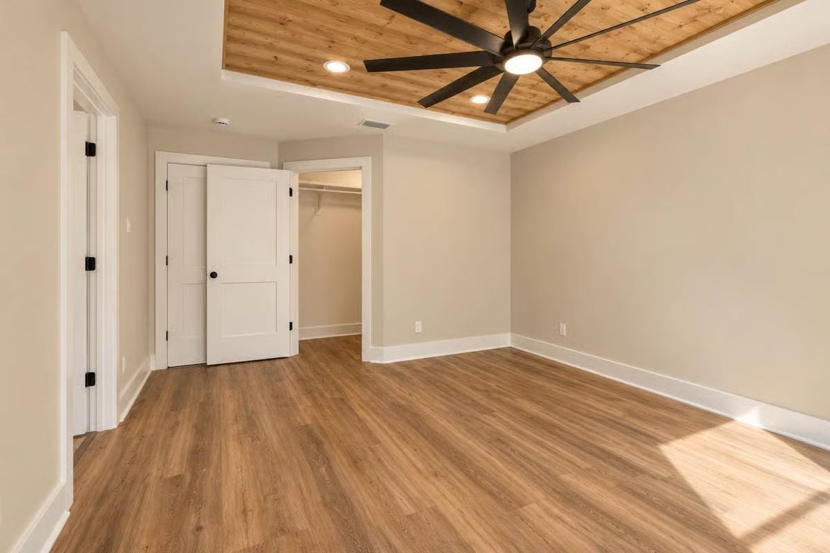 Tray Ceiling in Wood, Wide-Plank Floor, and a Closet Worth Keeping