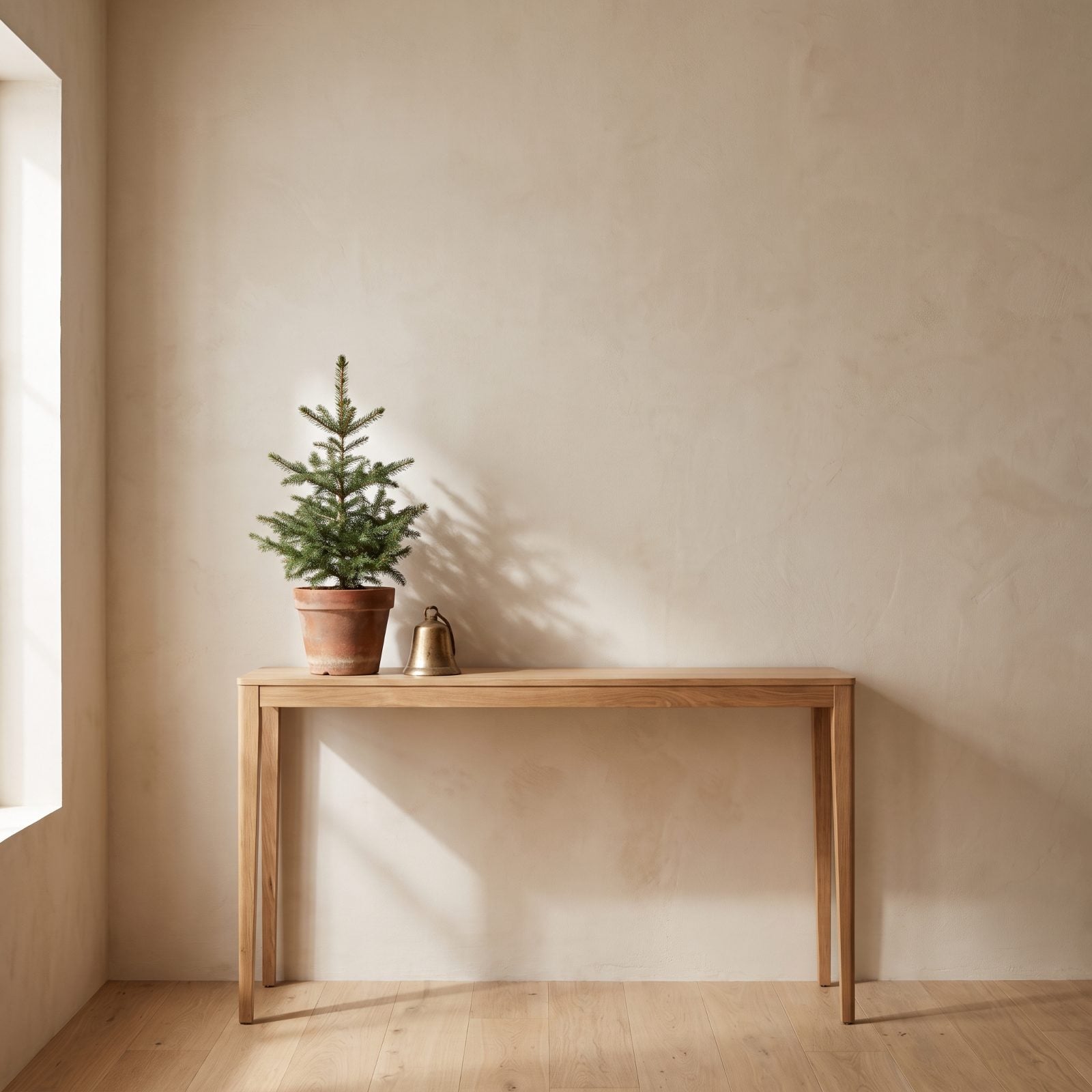 An Entry Console With a Tiny Potted Spruce and One Brass Bell