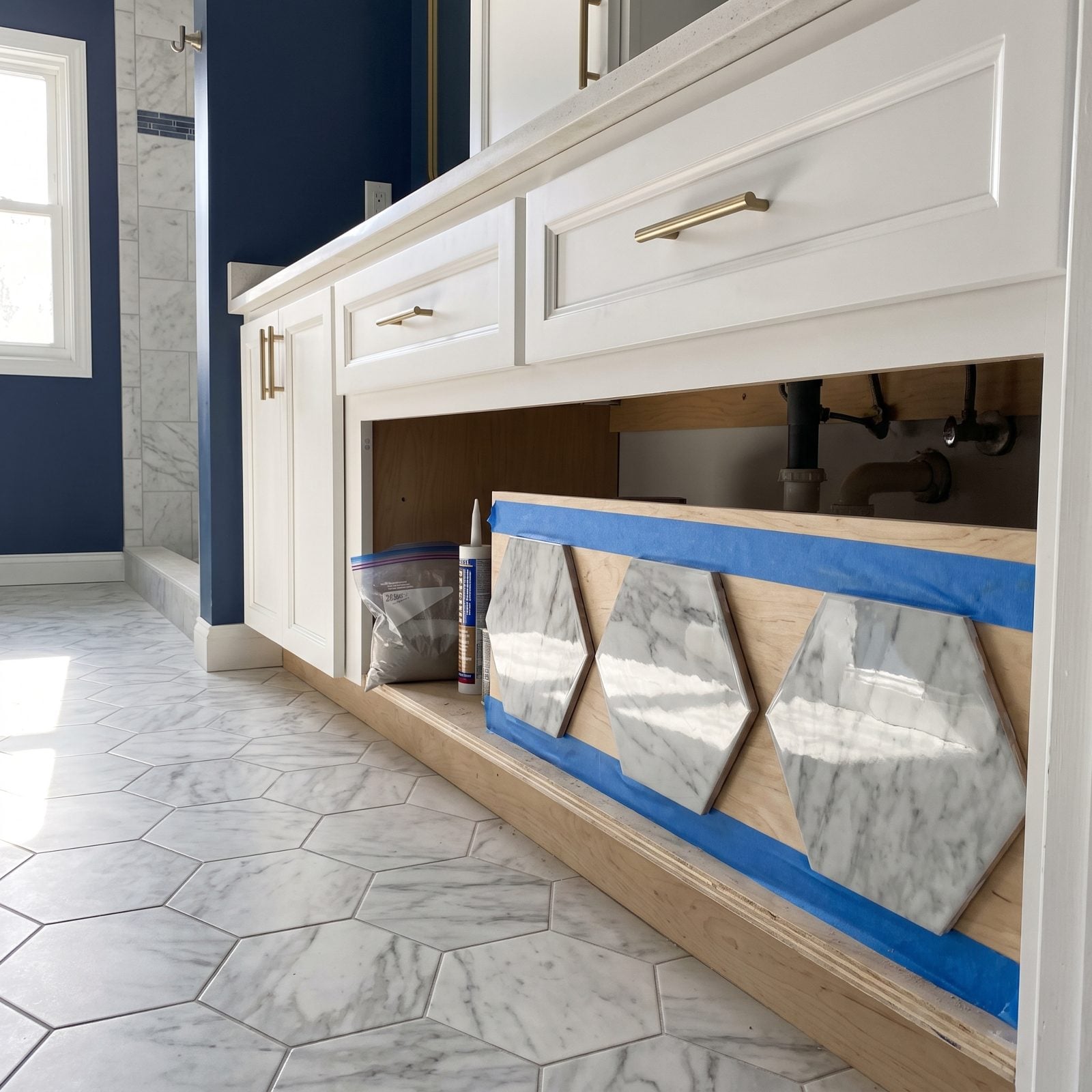 Extra Tiles Taped Beneath a Vanity for Future Repairs