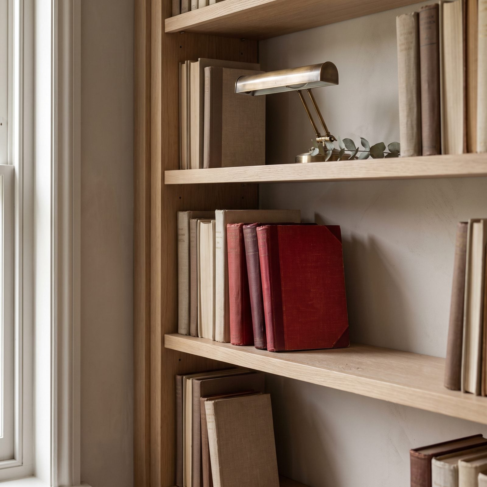 A Few Red Books Turned Outward on a Shelf