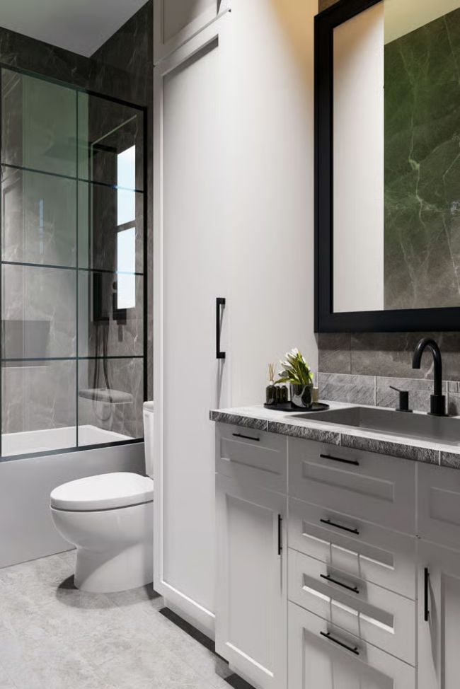 Black Fixtures, Grey Marble, and a Shower Door That Makes the Room Feel Bigger