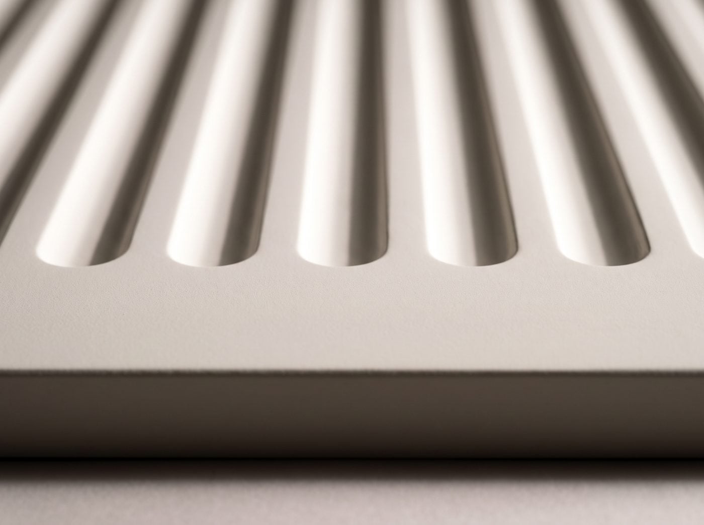 Fluted detail: concave flutes ending in rounded stops above a plain band.