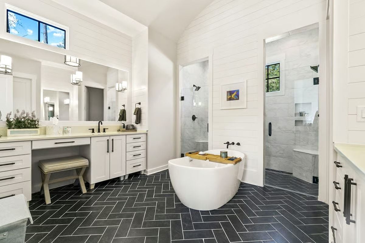 Dark Herringbone Floor Doing All the Heavy Lifting in an All-White Bathroom