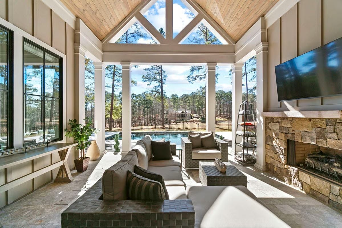 Open-Air Living Room Where the Pool View Competes With the Fireplace