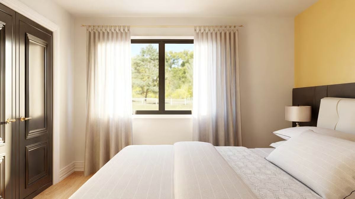 Pinch-Pleat Curtains and a Yellow Accent Wall That Actually Earns Its Place