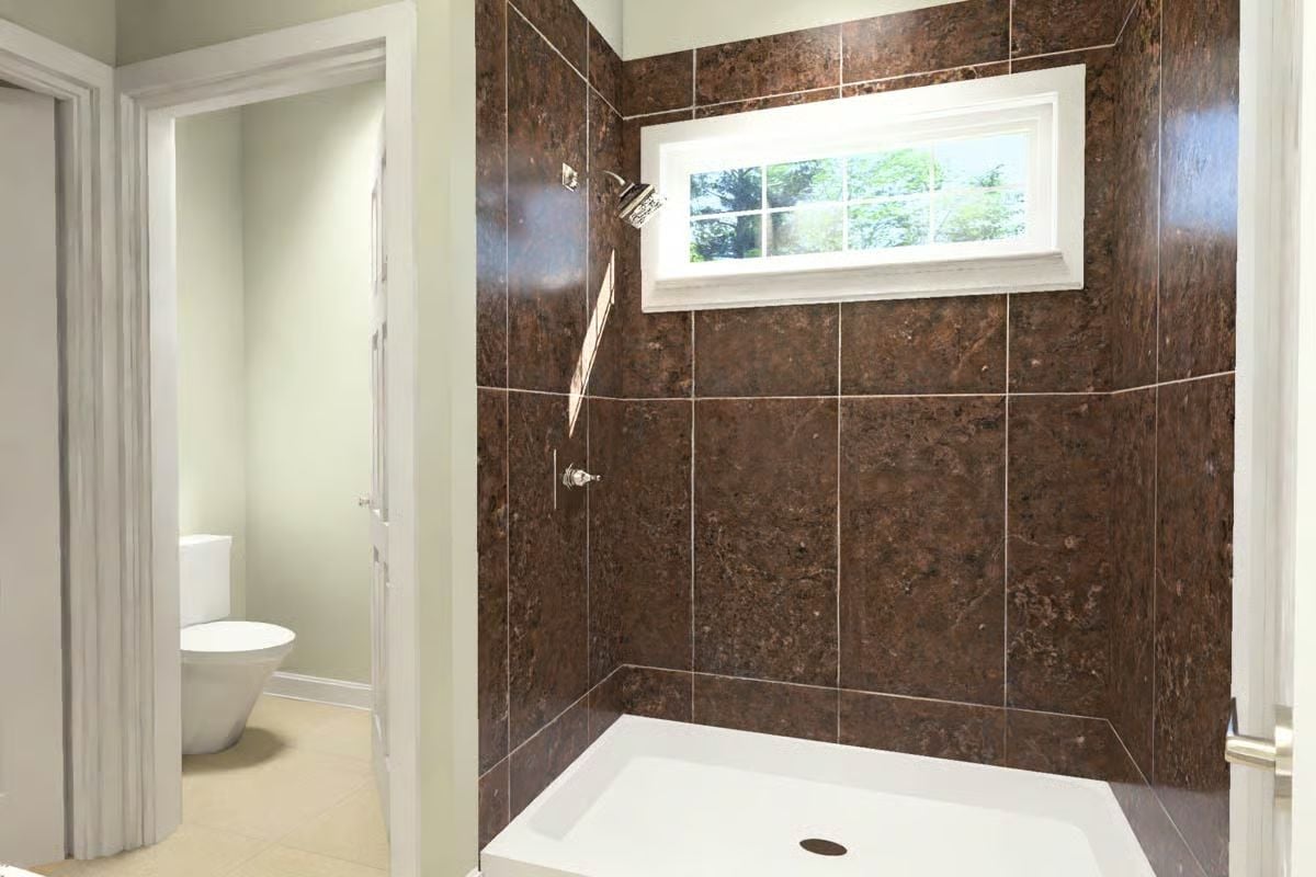 Dark Granite Tile and a Window That Pulls the Outdoors Into the Shower