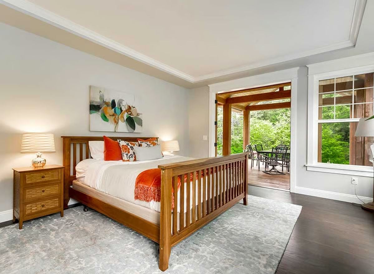 Craftsman Bed Frame, Orange Throw, and a Door That Opens Straight to the Trees