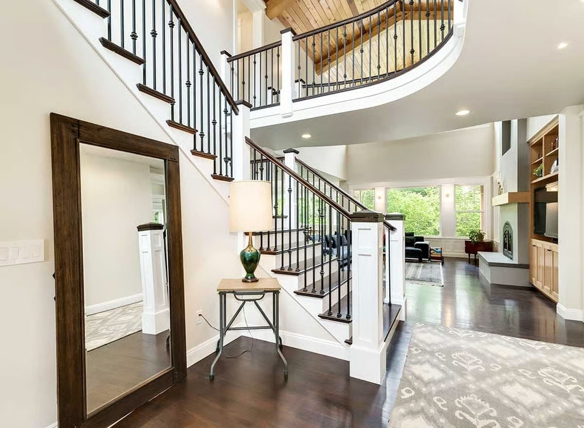 Curved Balcony, Iron Balusters, and a Foyer That Earns Its Square Footage