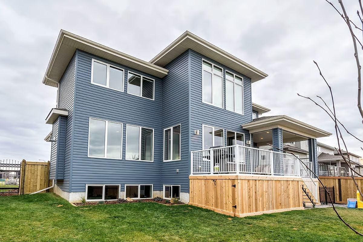 Blue Lap Siding, a Cedar Deck Skirt, and a Roofline That Refuses to Be Ignored