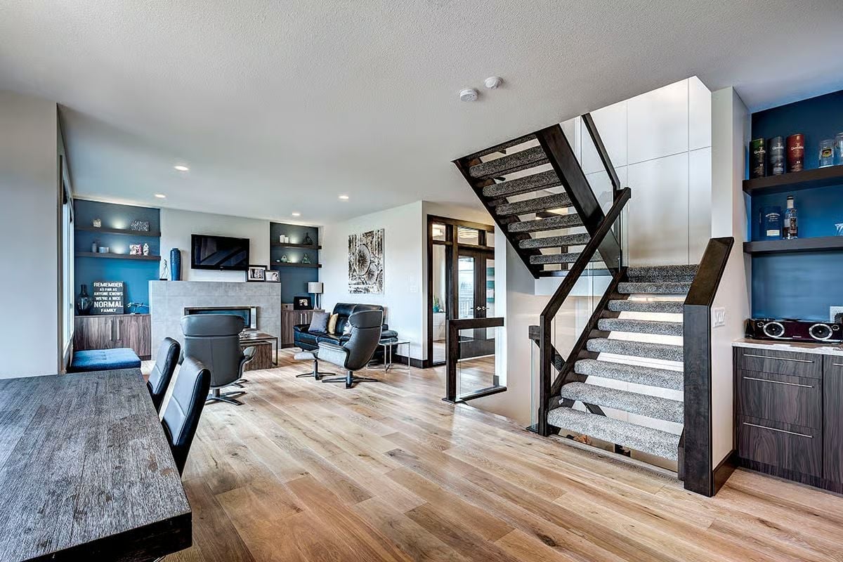 Floating Stairs and a Bar Shelf Full of Whiskey Set the Tone Here