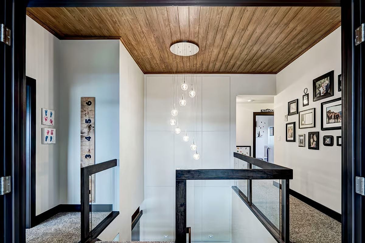 Glass Globe Pendants Cascading Over a Stairwell That Actually Earns the Attention