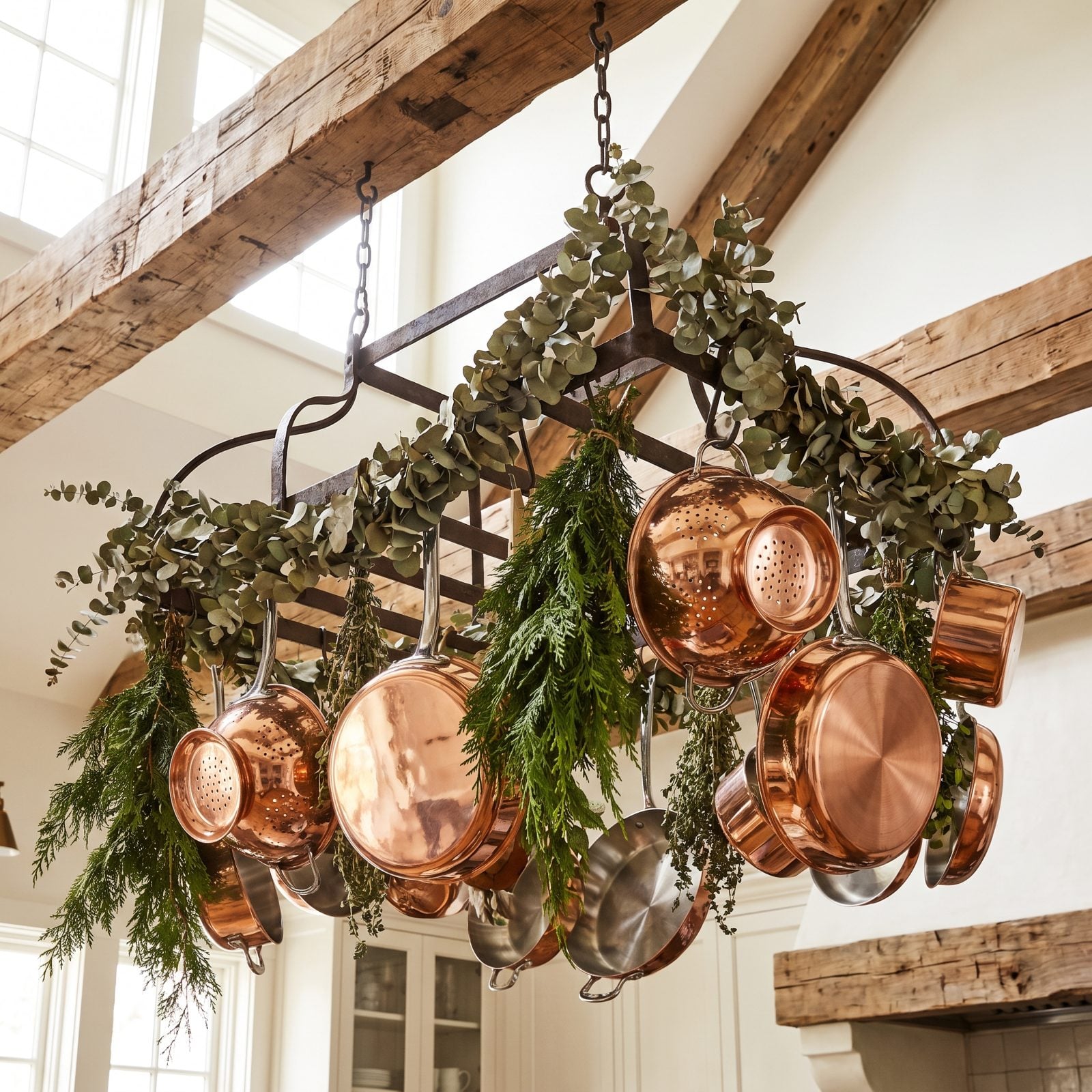 A Kitchen Ceiling Rack Hung With Greenery and Copper Cookware