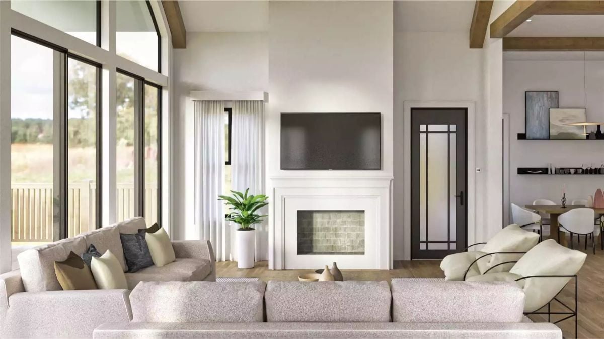 Warm Wood Beams and a White Fireplace Surround Anchor This Lake House Living Room