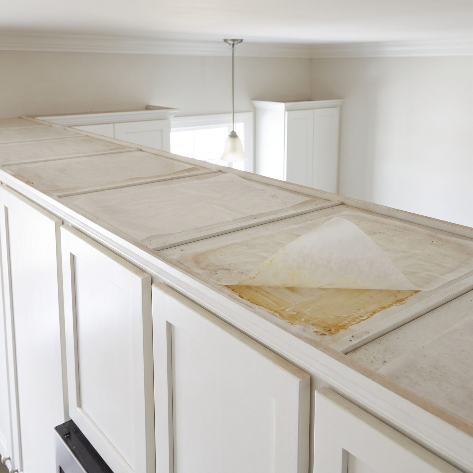 Lay Wax Paper on Top of Cabinets to Catch Greasy Dust