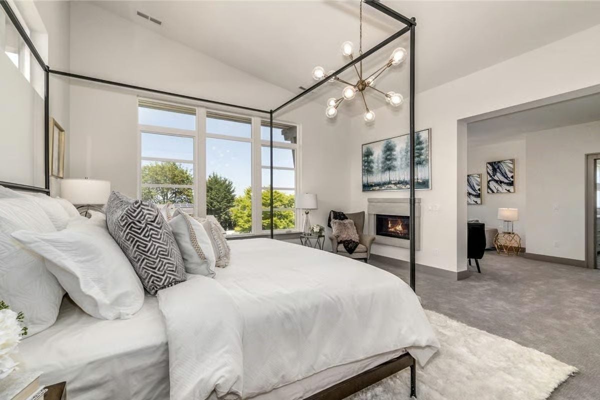 Canopy Bed, a Lit Fireplace, and Windows That Frame the Treetops Like a Painting