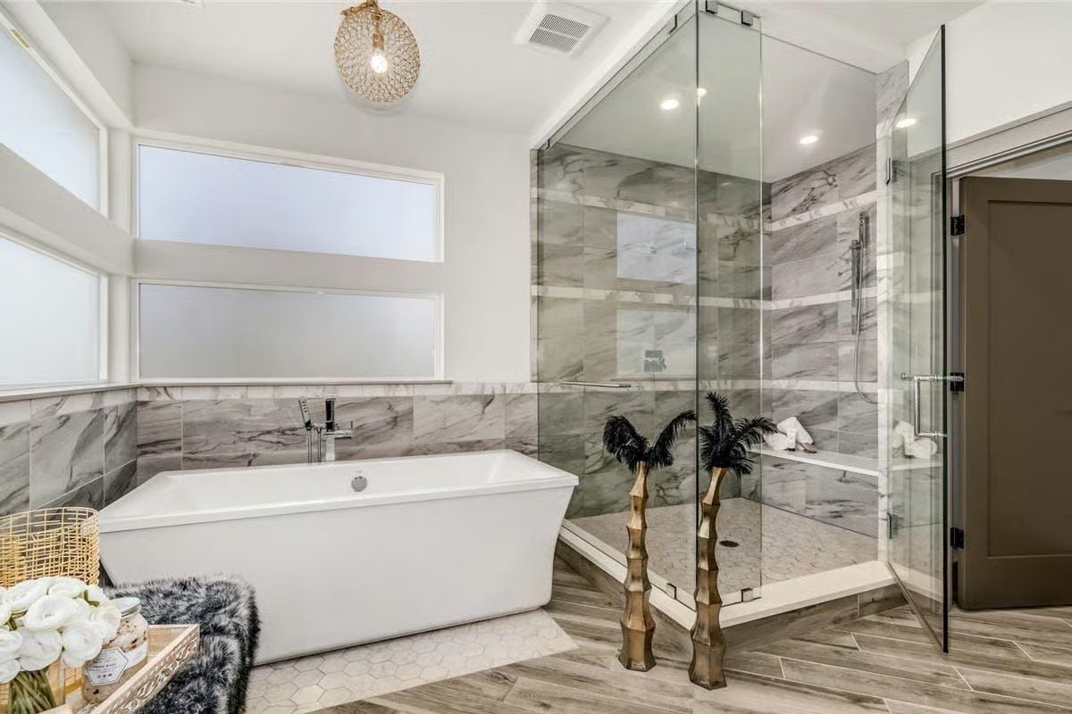 Freestanding Soaker, Marble Tile Walls, and a Glass Shower That Doesn't Cut Corners