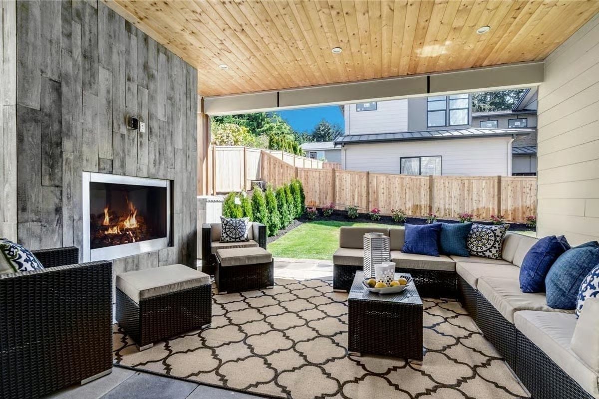 Reclaimed Wood Wall, an Outdoor Fireplace, and a Sectional Built for Eight