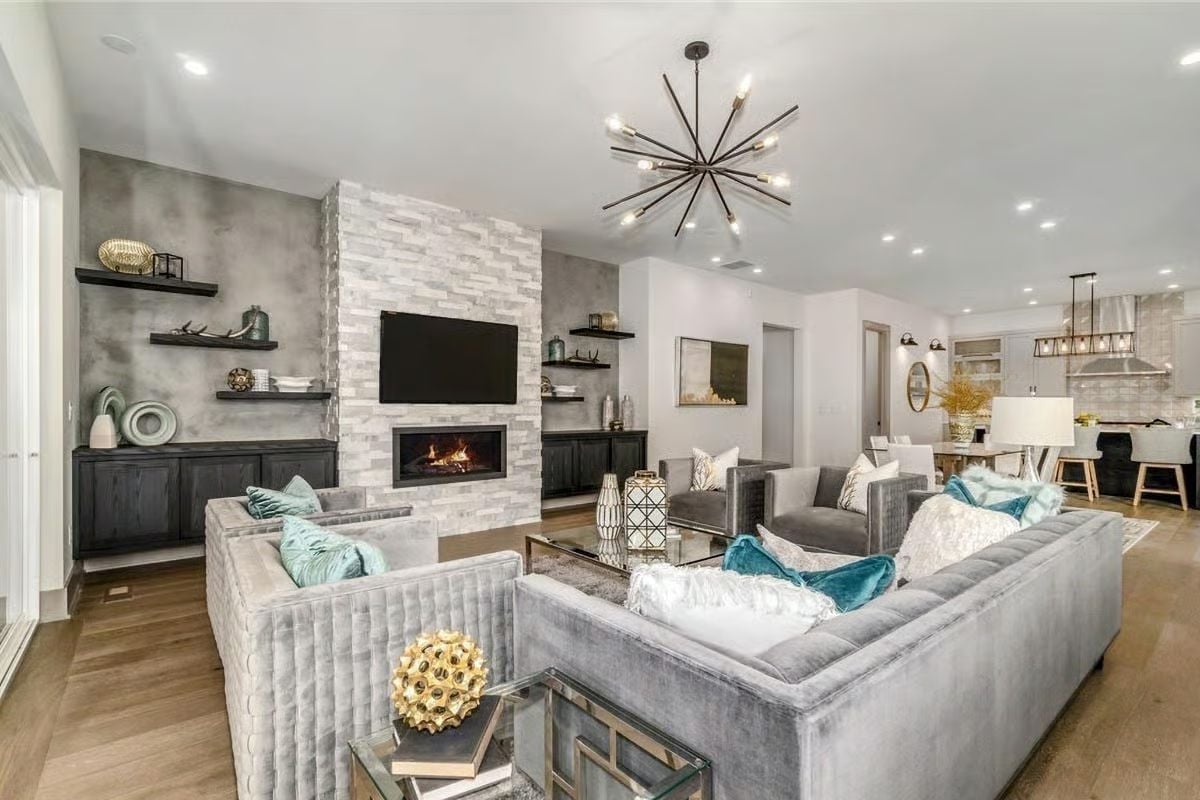 Stacked Stone Fireplace Wall and Velvet Sofas Make This Living Room Feel Like a Resort