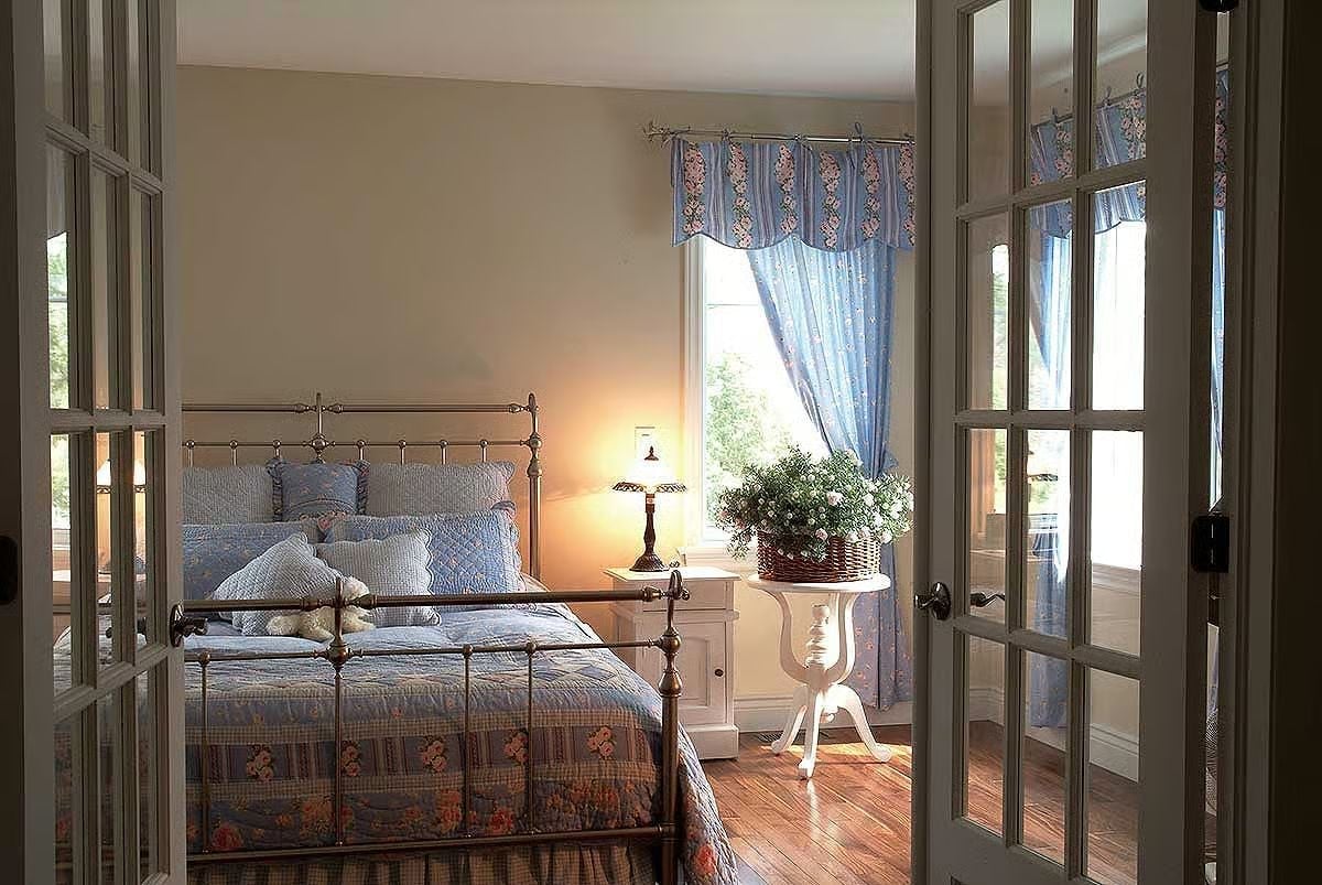 Brass Bed, Blue Quilts, and French Doors That Make an Entrance