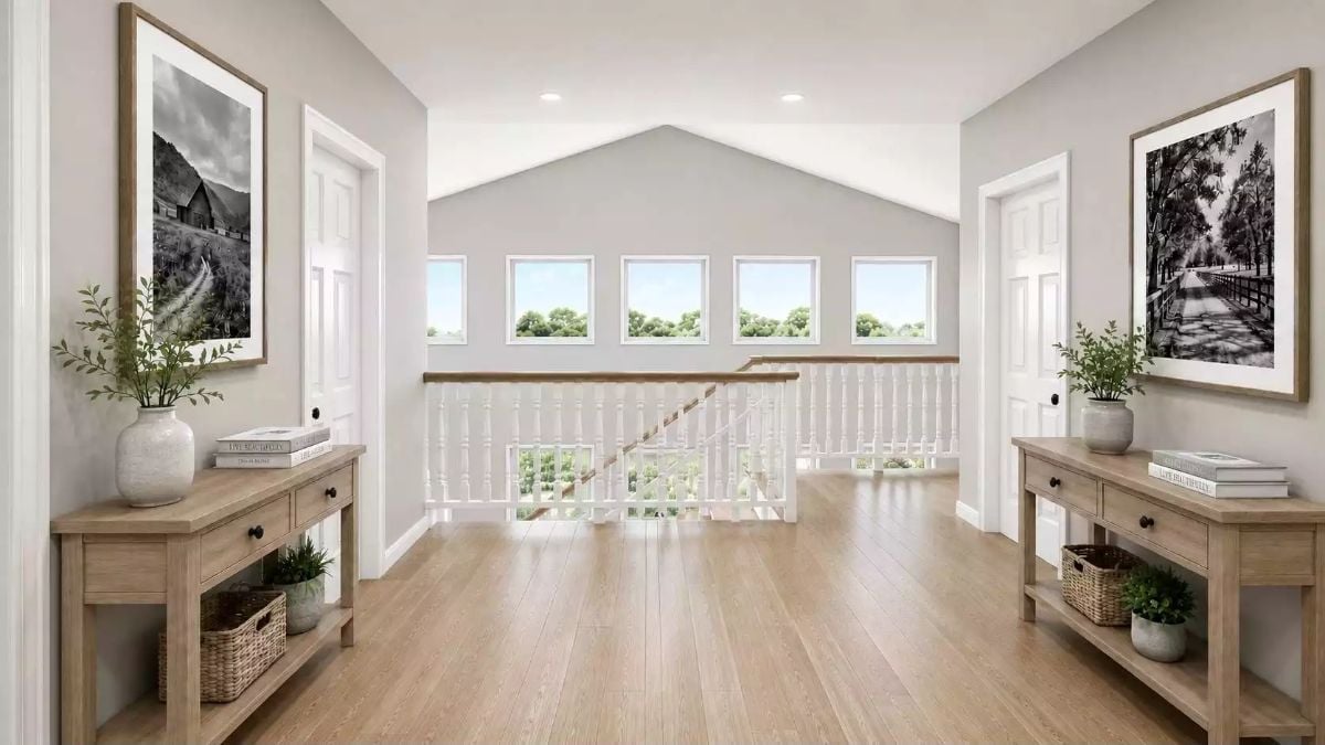 Symmetrical Hallway Landing With Paired Console Tables and a Staircase Rail View