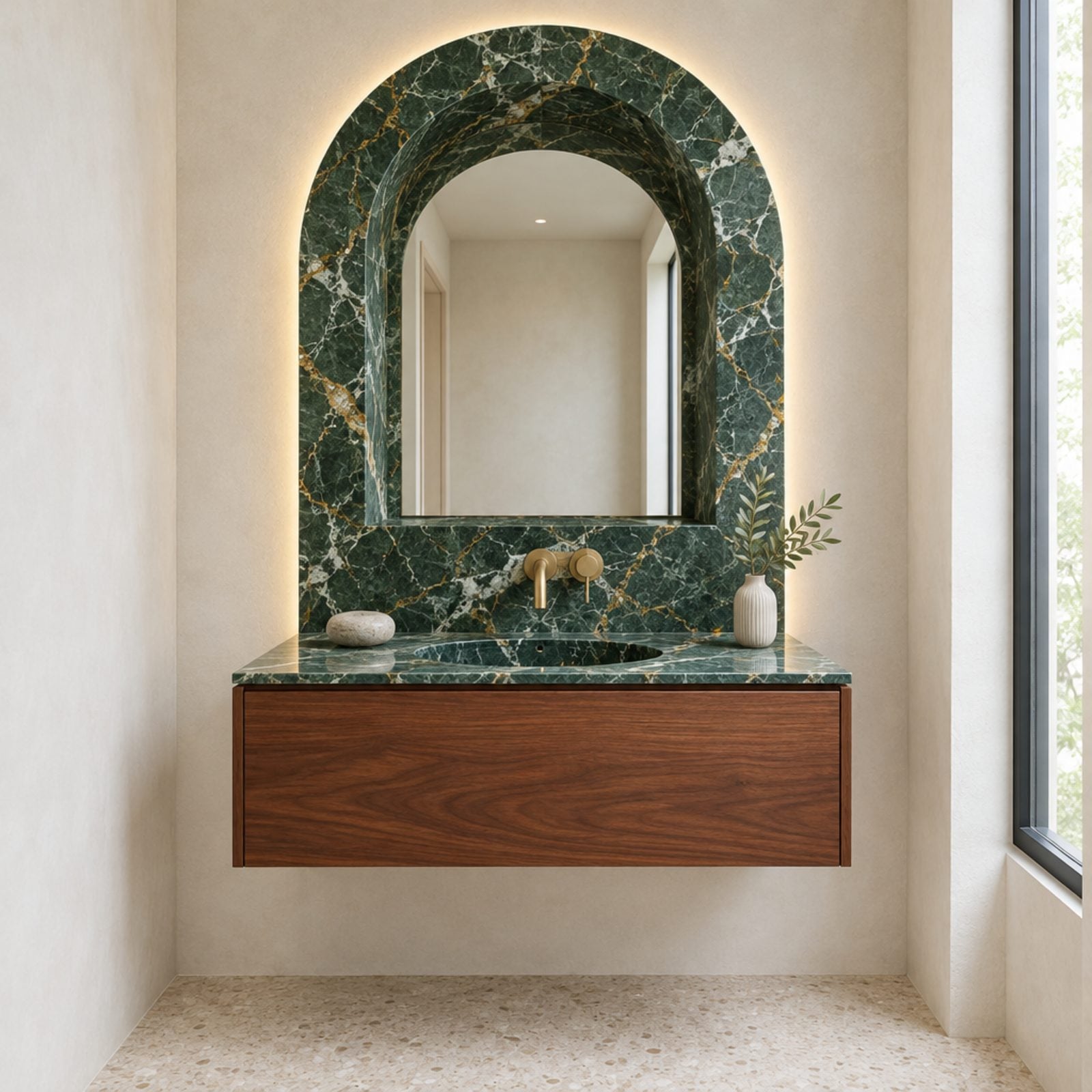 A Marble Portal Mirror Floats Over a Wall-Hung Walnut Vanity