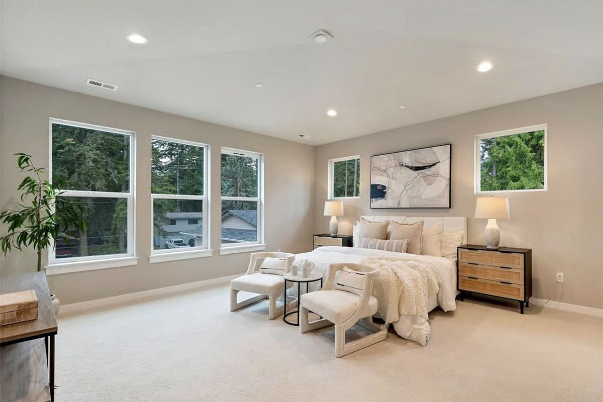 Carpet, Natural Light, and Two Chairs That Earn Their Place at the Foot of the Bed