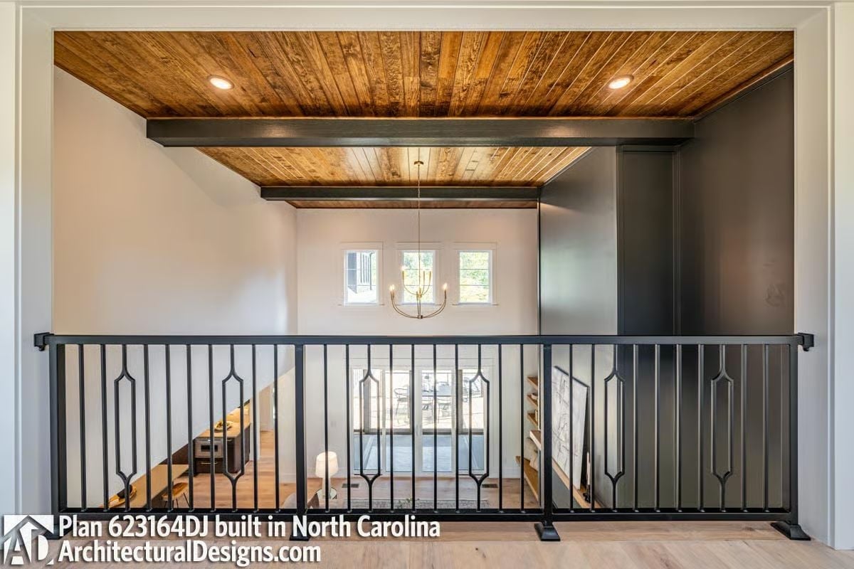 Metal Baluster Railing With Decorative Inserts Above a Two-Story Entry