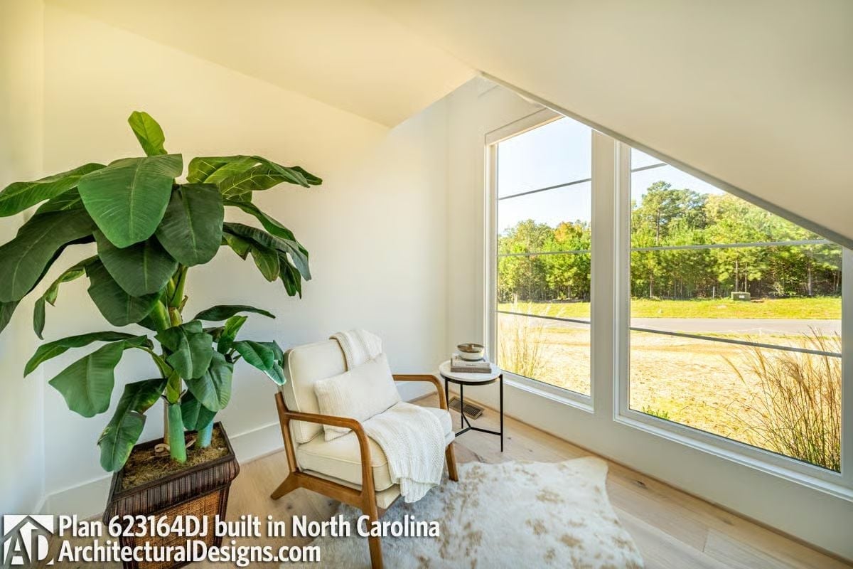 Vaulted Reading Nook With a Triangular Window Cut Into the Roofline