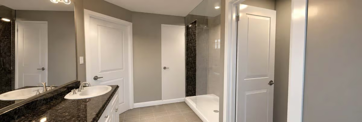 Double Sinks, Dark Granite, and a Shower That Doesn't Need a Door to Feel Finished