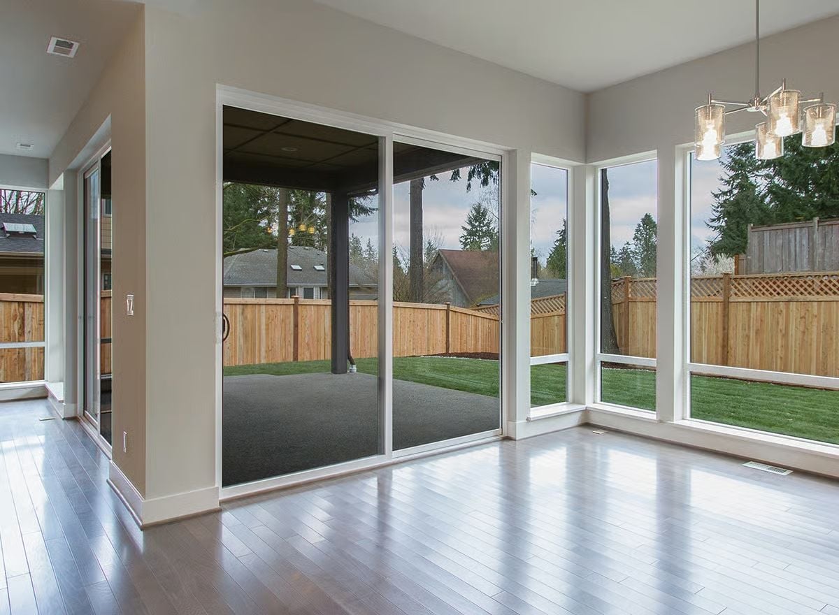 Sliding Glass Doors and Corner Windows Pull the Backyard Into Every Conversation