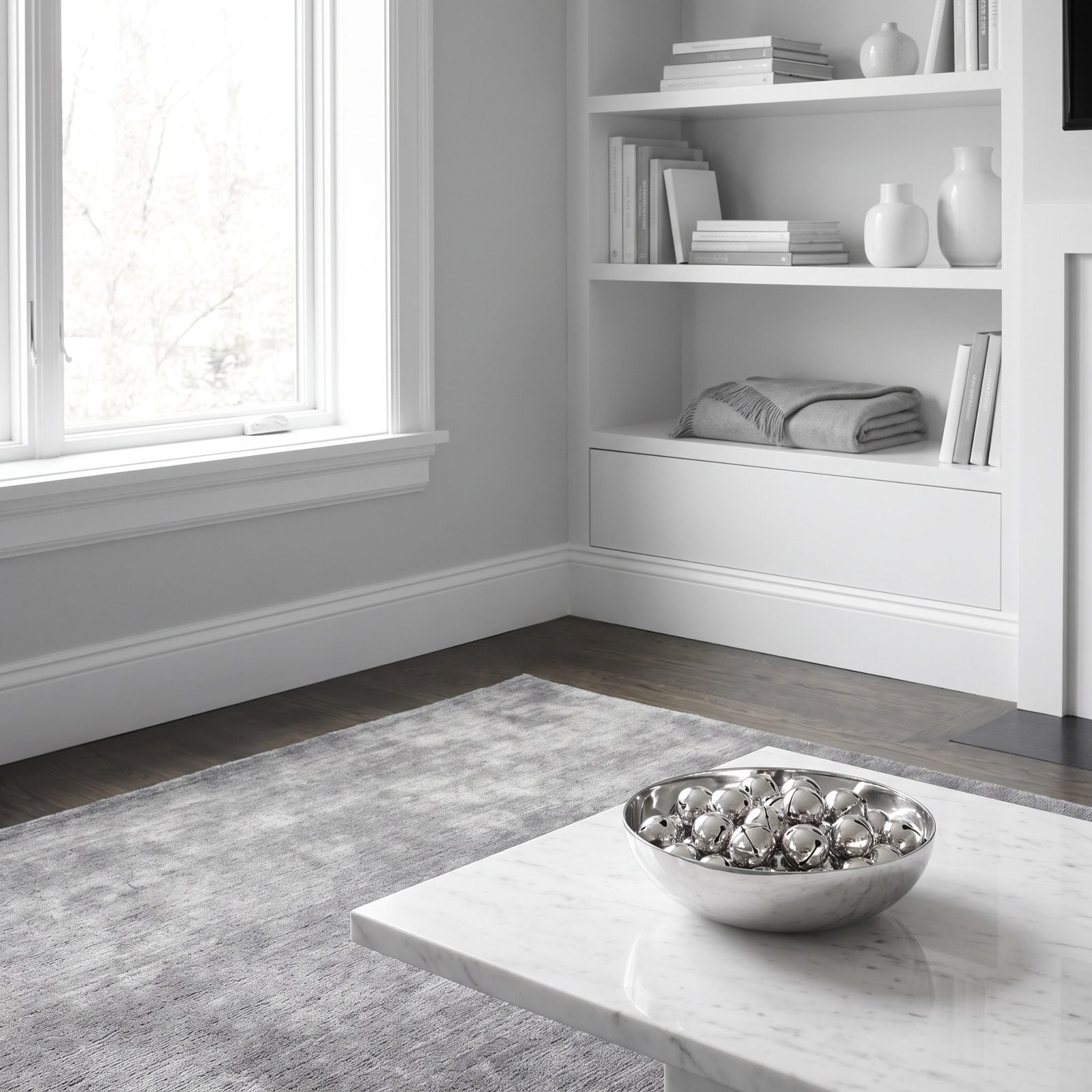 A Monochrome Room Accented by One Bowl of Silver Bells