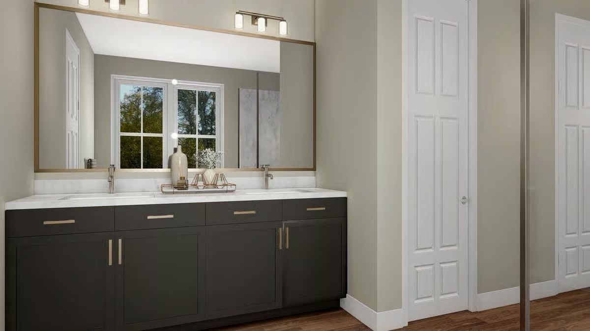 Dark Vanity Cabinets and a Gold-Framed Mirror That Pull the Room Together