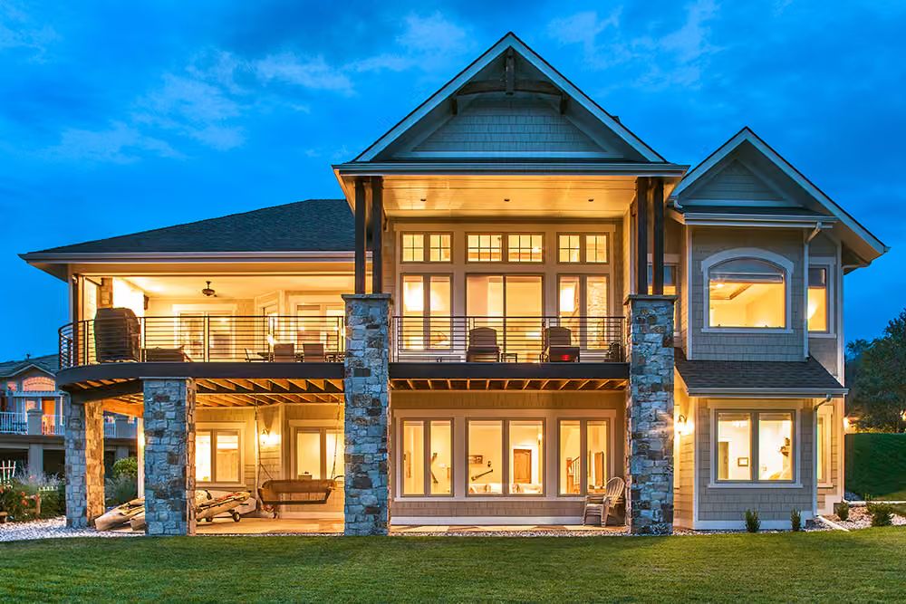Stone Columns, Wraparound Decks, and a Glow That Says Someone's Always Home