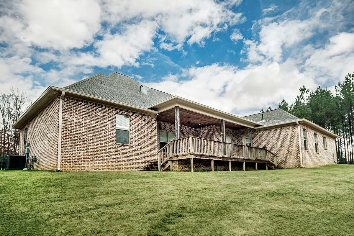 Covered Rear Porch Gives This Brick Acadian a Backyard Worth Staying In
