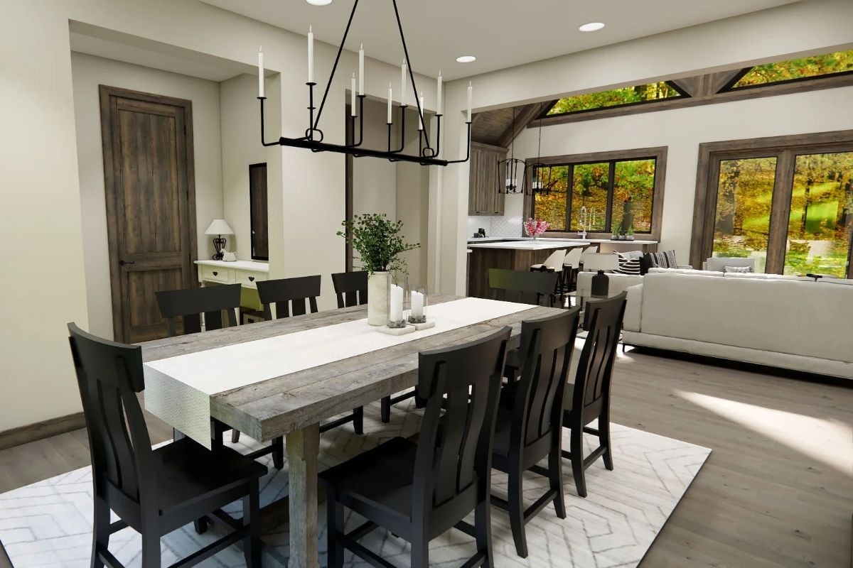Weathered Table, Black Chairs, and a Chandelier That Earns Its Keep