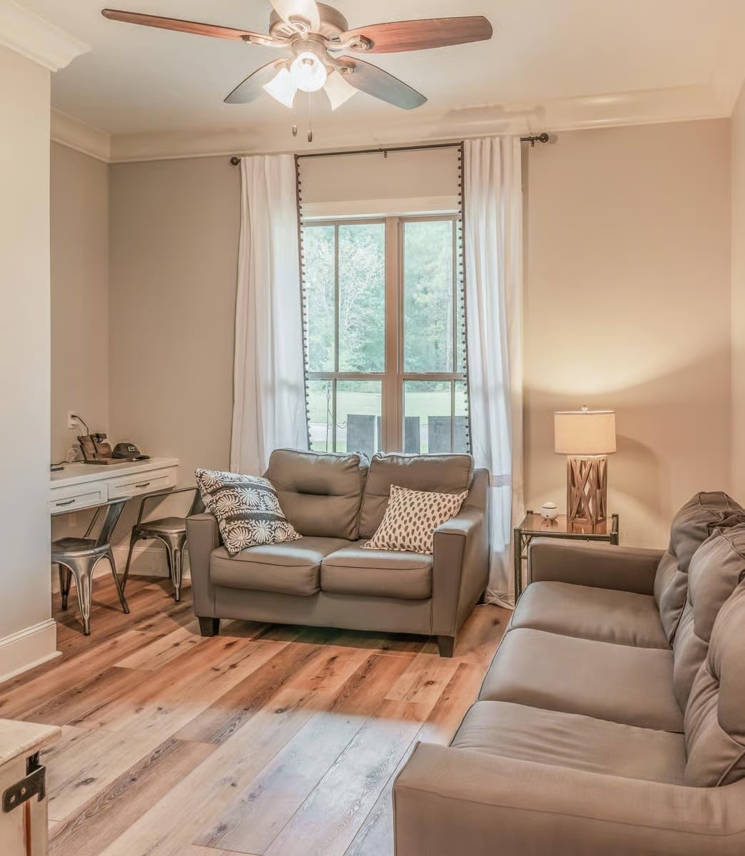 Leather Loveseats and Hardwood Floors Make Quiet Rooms Feel Lived In