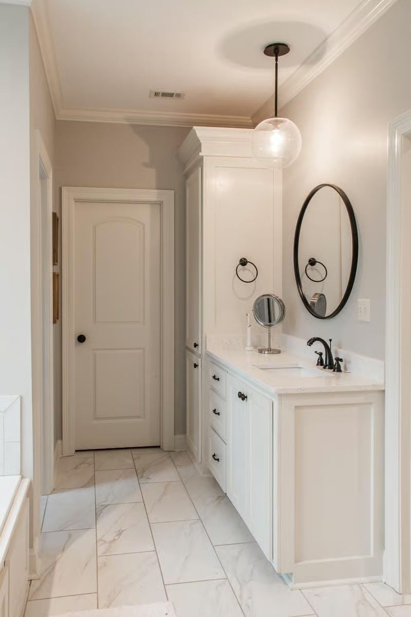 Oval Mirror, Globe Pendant, and a Vanity Tower That Earns Its Footprint