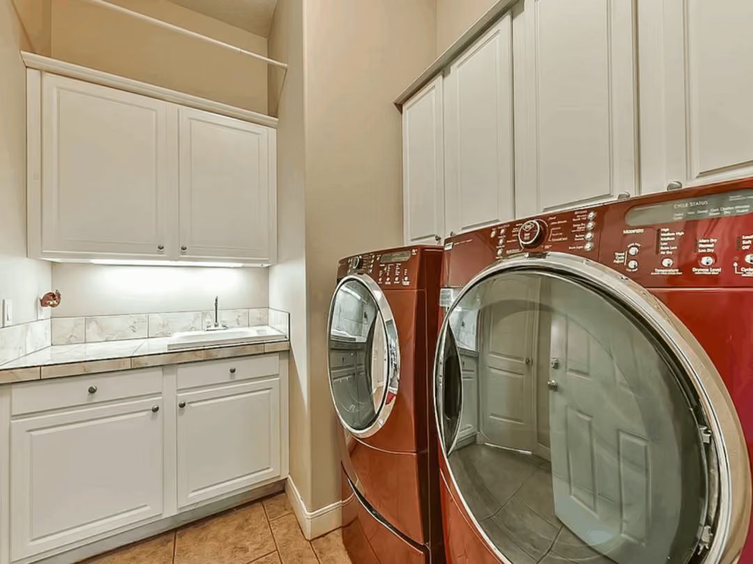 Red Front-Loaders and Cabinets That Pull Laundry Rooms Out of the Basement Era