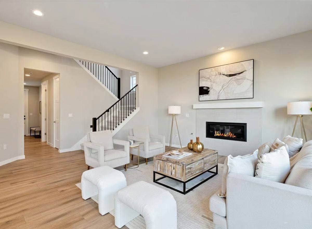 Gold Accents and a Live Flame Pull This White Living Room Back From the Edge