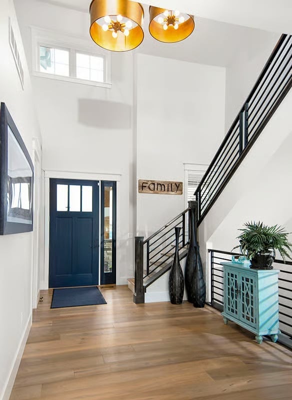 Gold Drum Pendants and a Navy Door Set the Tone Before You Take a Step Inside