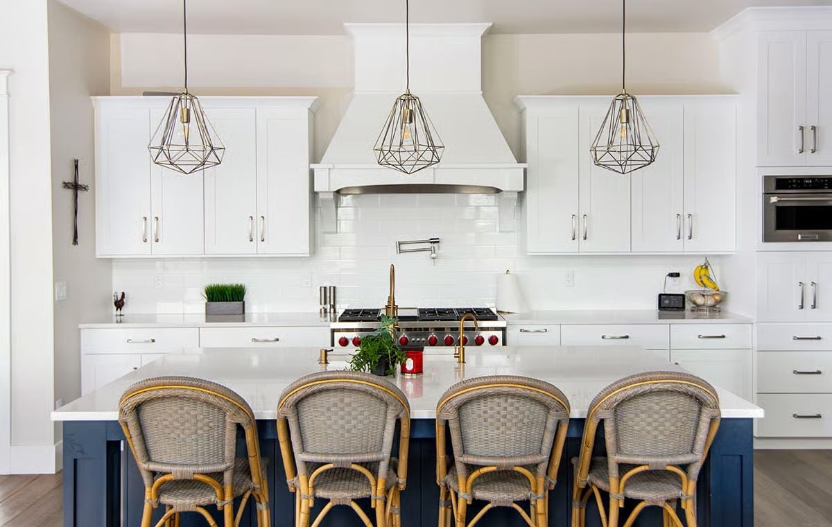 Woven Rattan Barstools Pull Warmth Into an Otherwise All-White Kitchen