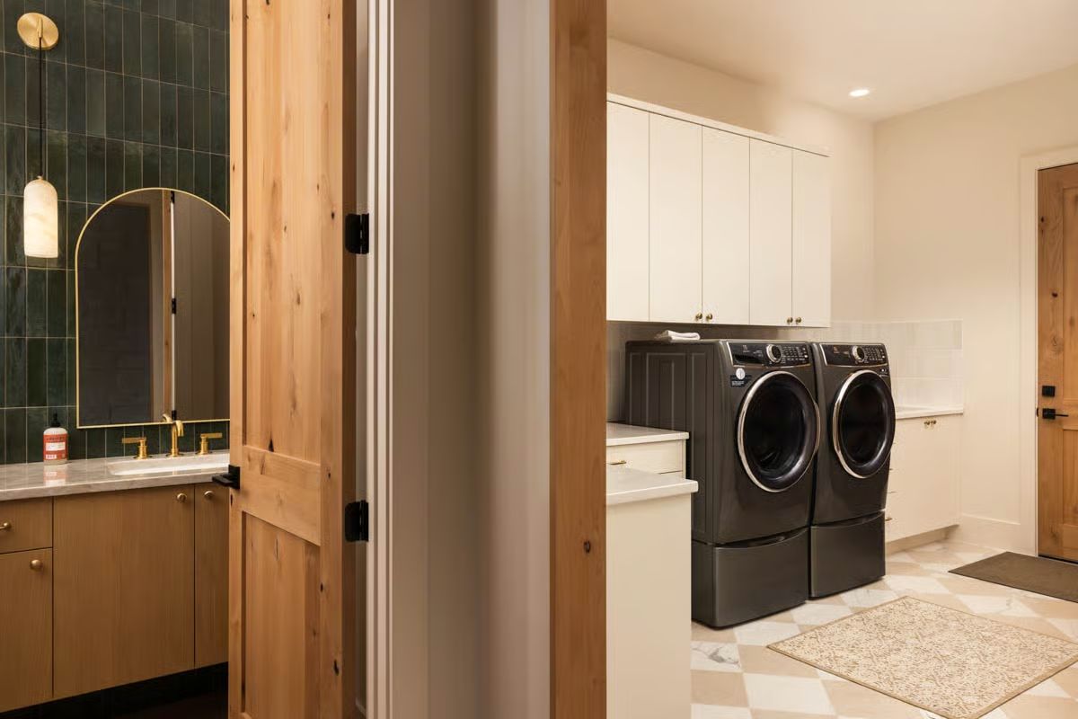 Dutch Door Opens Between a Dark-Tiled Bath and a Laundry Room That Actually Works