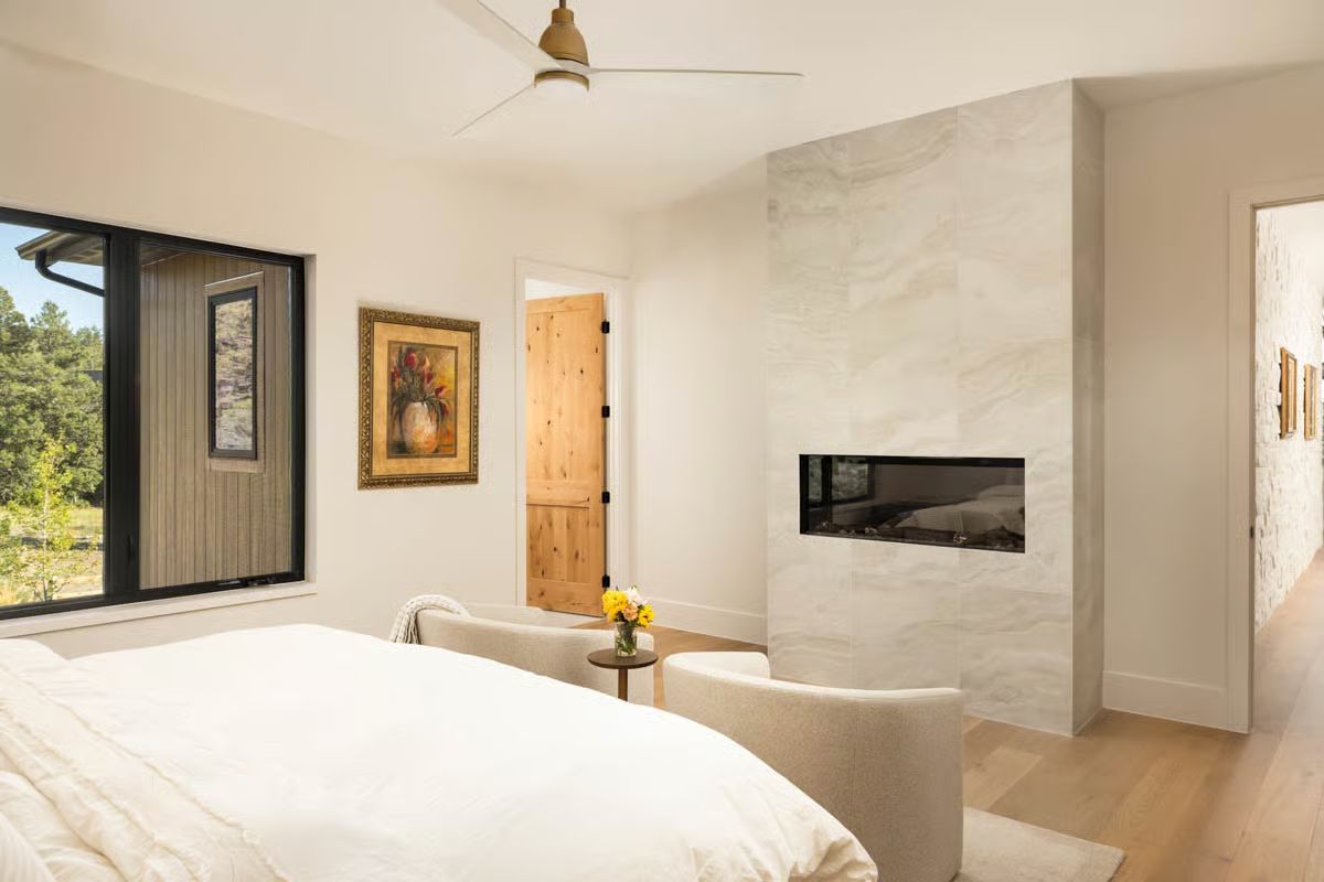 Marble Fireplace Wall and a See-Through Firebox That Works Both Rooms