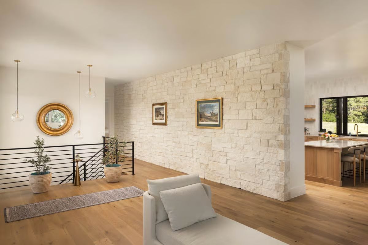 Stone Wall, Two Paintings, and a Kitchen That Knows Its Place